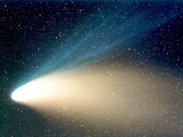 A Star Cluster Through Hale-Bopp’s Tail