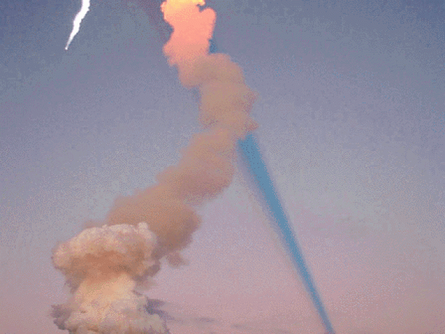 Shuttle Plume Shadow Points to Moon