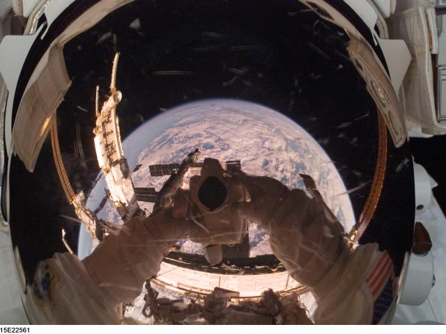 Orbiting Astronaut Reflects Earth