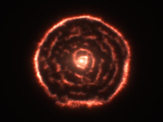 A Spiral Nebula Surrounding Star R Sculptoris
