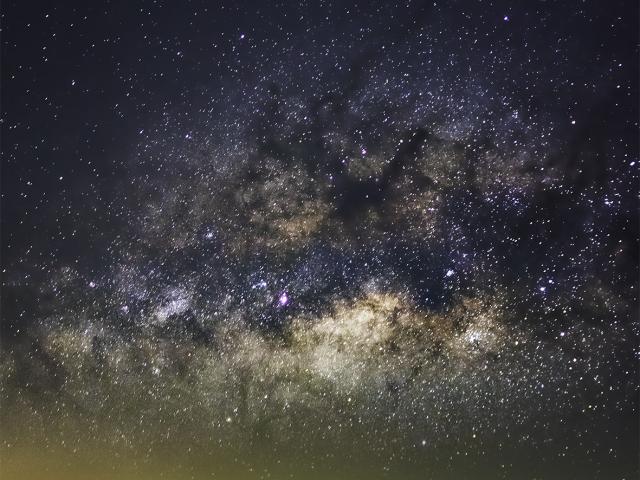 Milky Way over Erupting Volcano