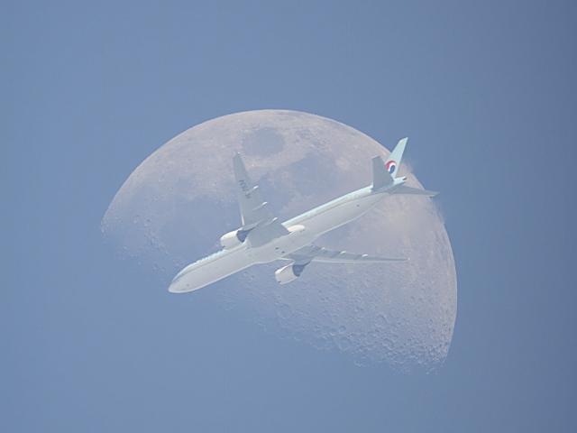 An Airplane in Front of the Moon