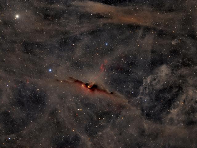 The Red Glow of the Cosmic Bat Nebula