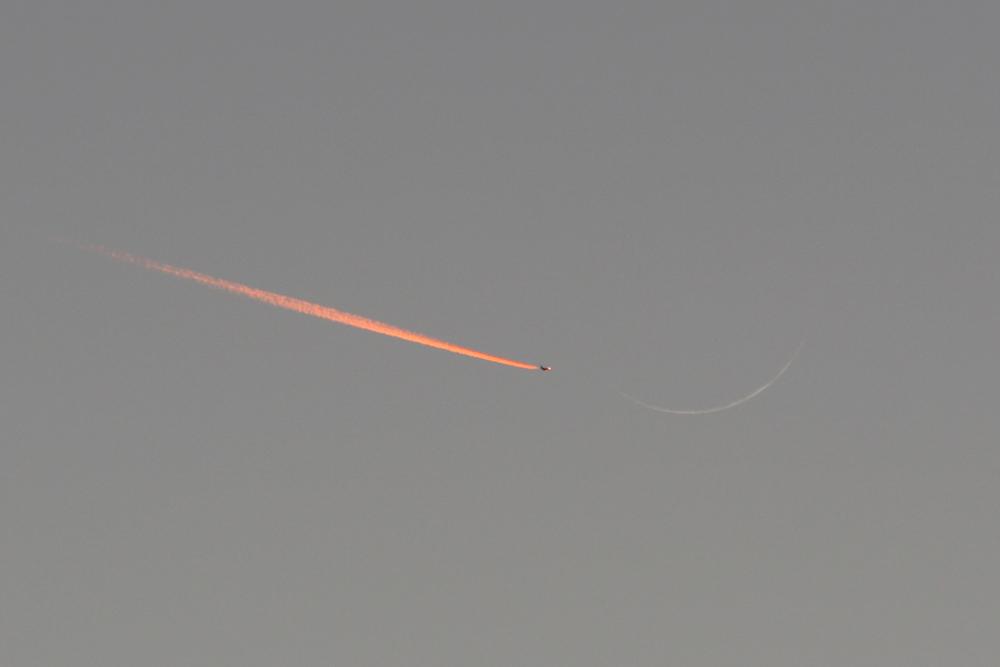 Jet Approaching a Crescent Moon