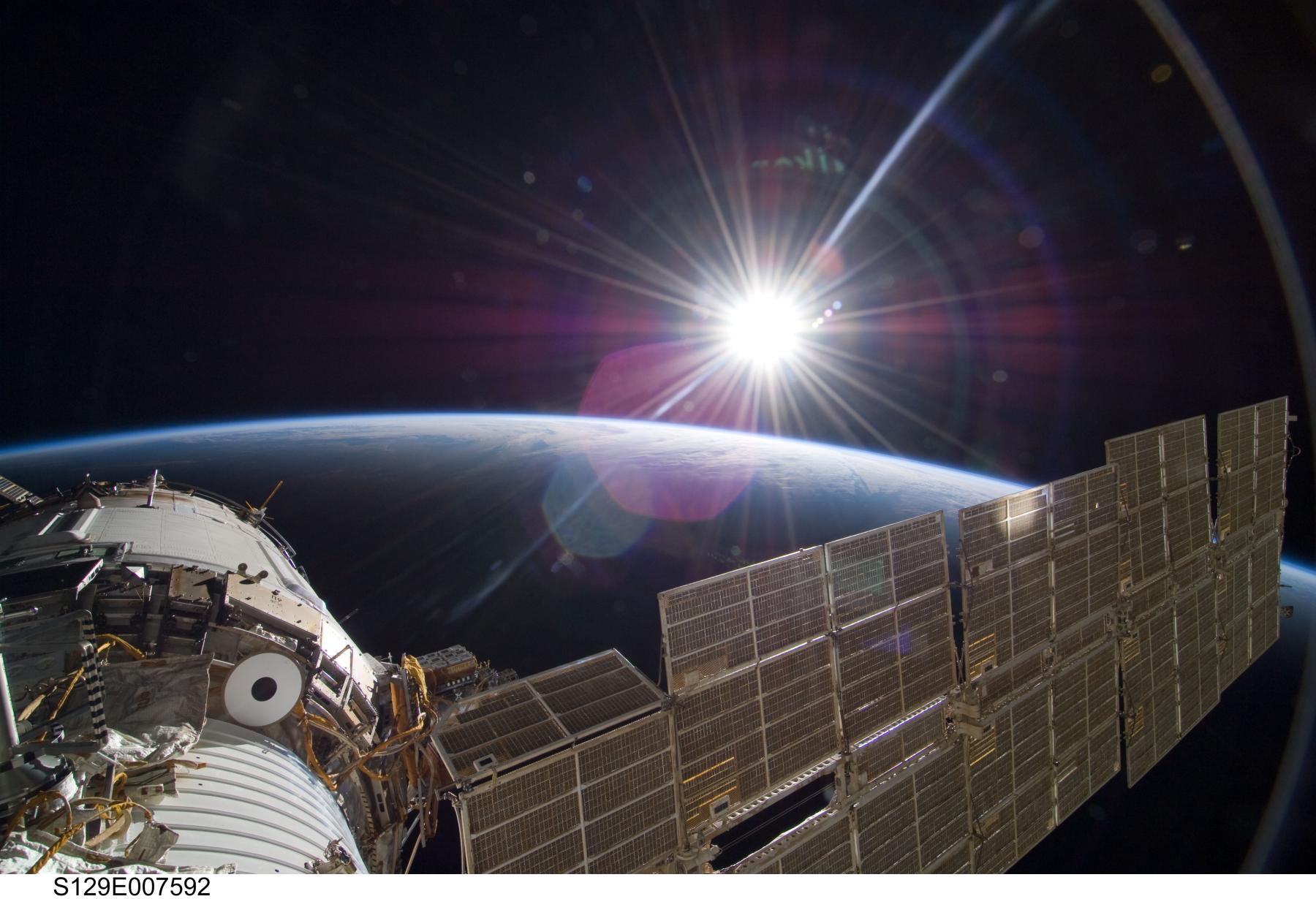 Bright Sun and Crescent Earth from the Space Station