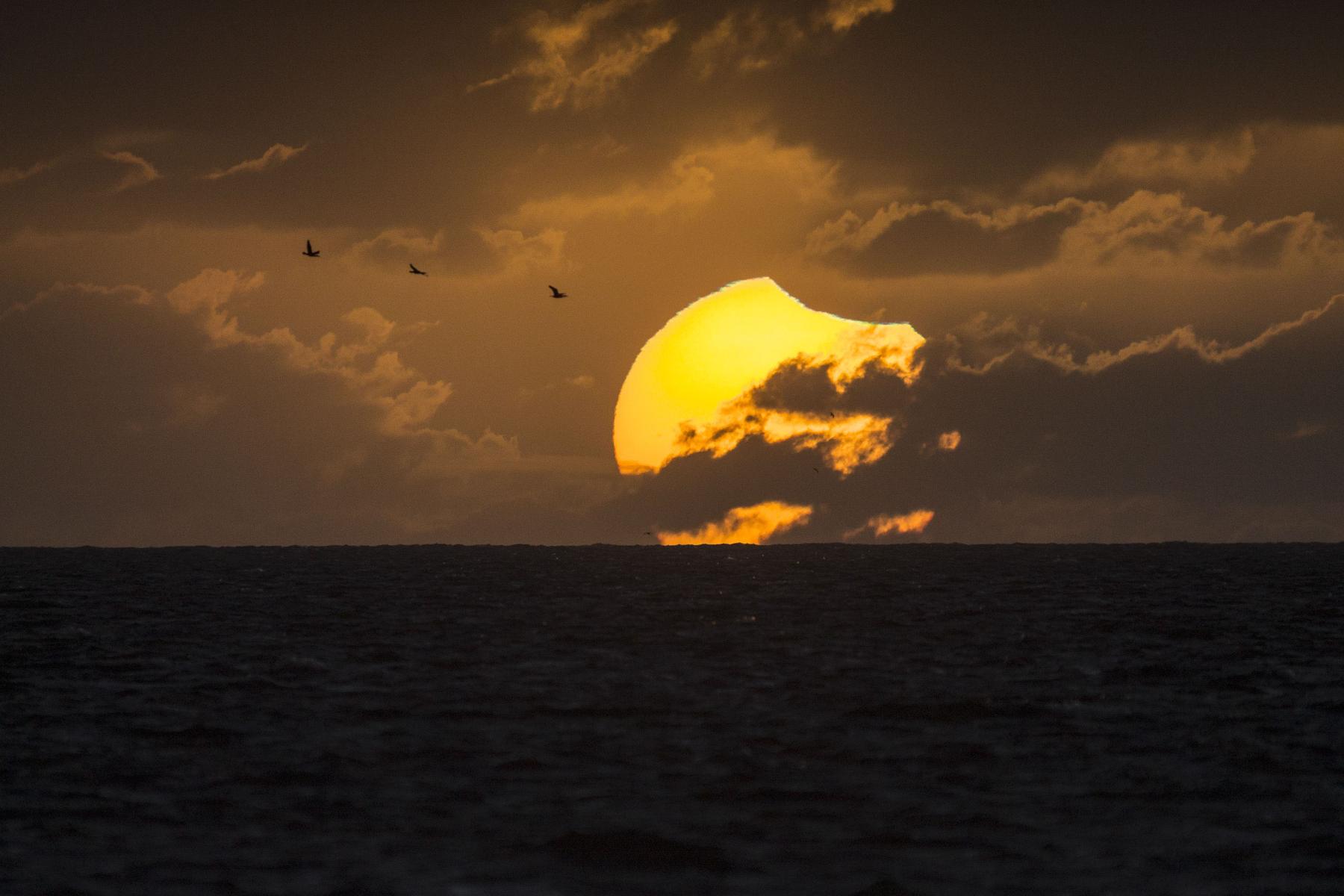 A Partially Eclipsed Setting Sun