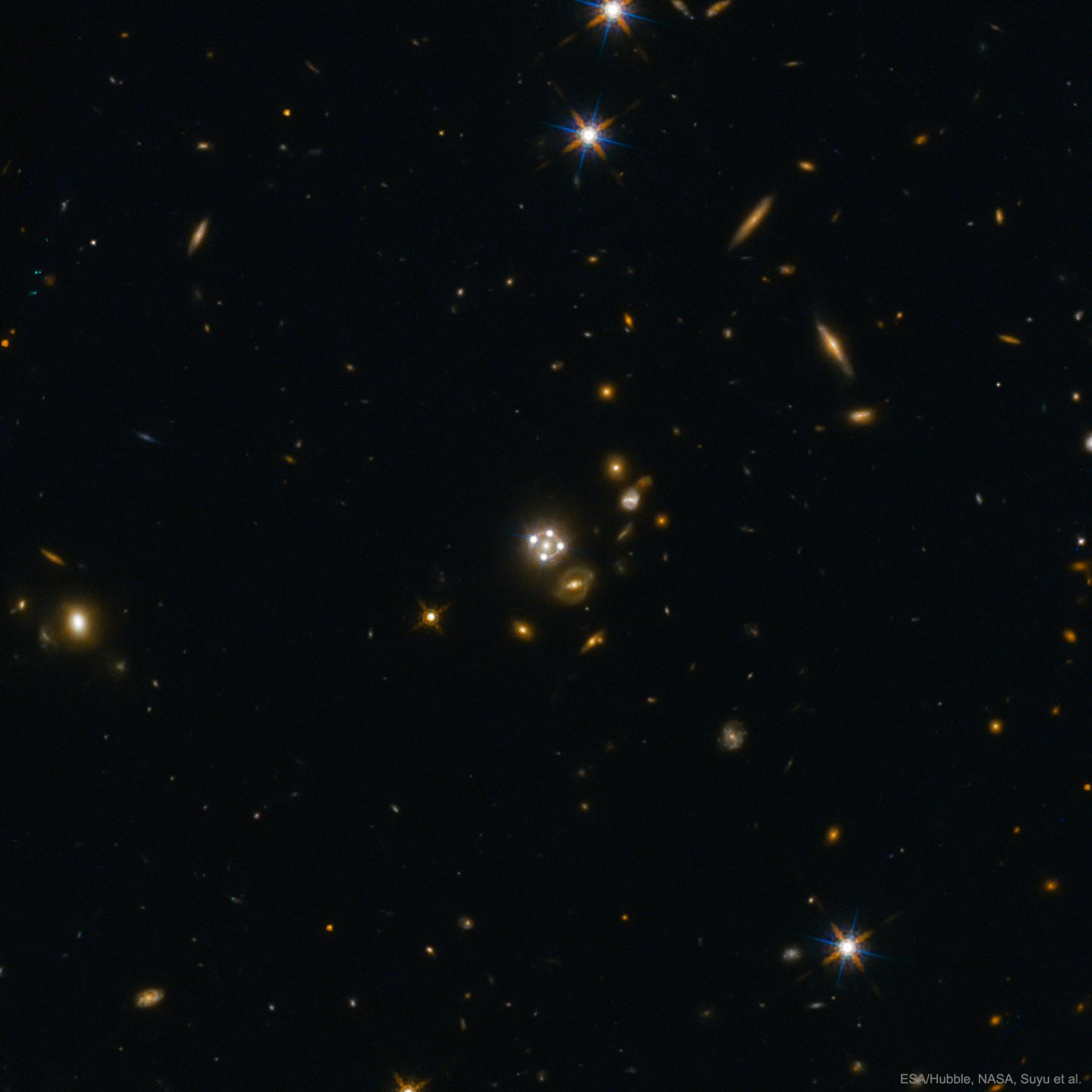 Four Quasar Images Surround a Galaxy Lens