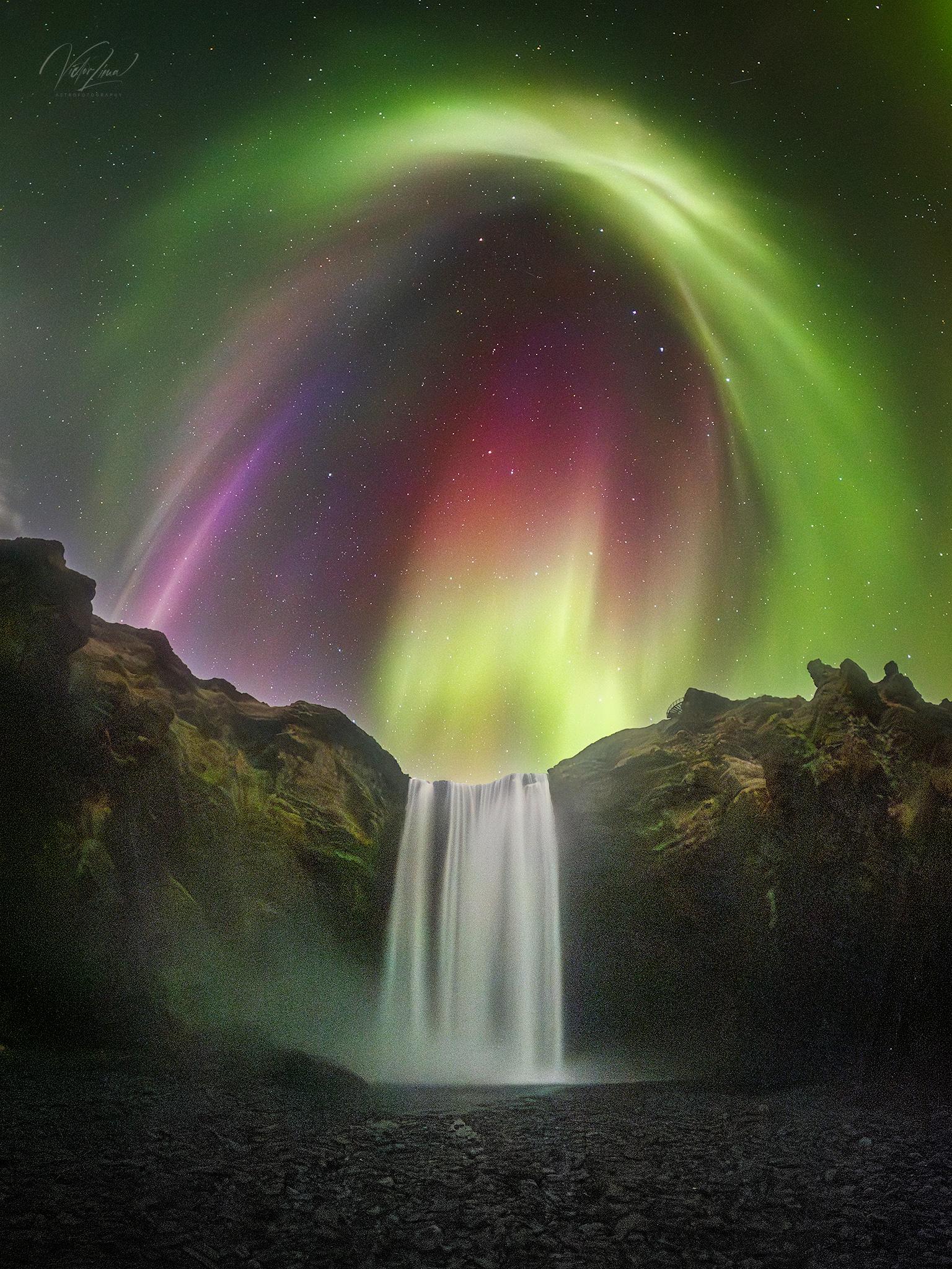 Colorful Aurora over an Icelandic Waterfall