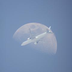 An Airplane in Front of the Moon