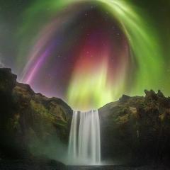 Colorful Aurora over an Icelandic Waterfall